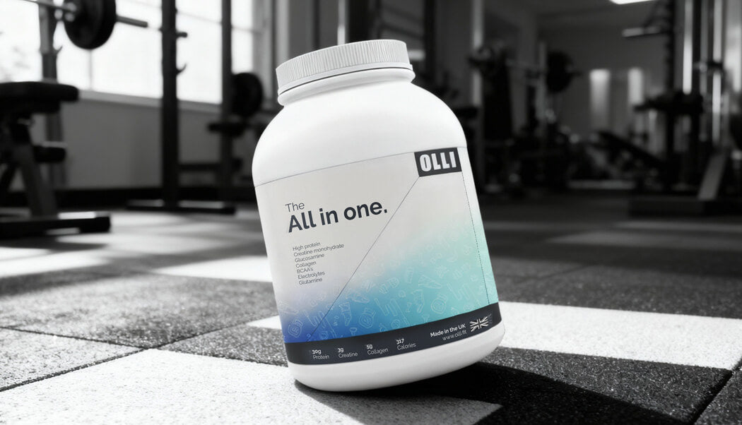 Supplement container labeled 'All in one' on a gym floor with blurred equipment in the background