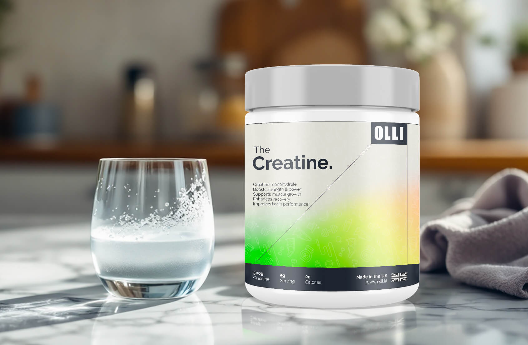 Olli Creatine supplement container with a glass of water on a kitchen counter