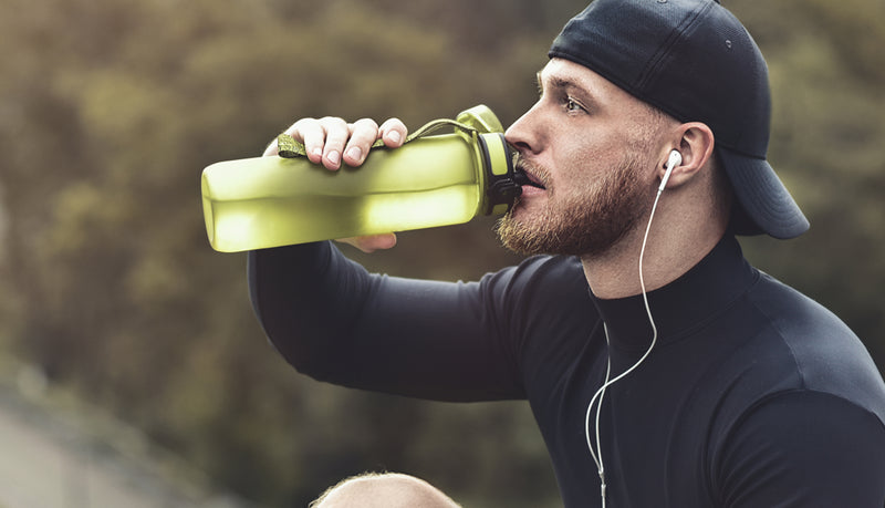 Man drinking from BCAA from a water bottle