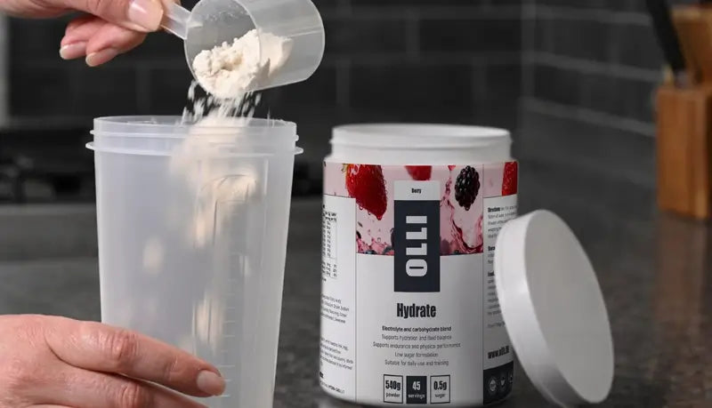 Pouring Olli Hydrate electrolyte blend drink into a shaker