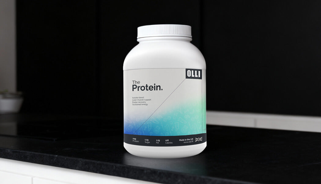 Protein powder container labeled 'The Protein' by OLLI on a kitchen counter.