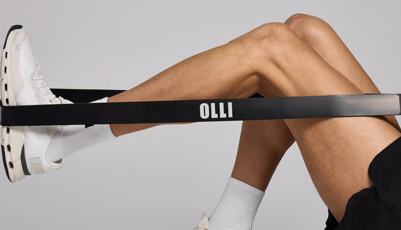 Person using an OLLI resistance band with a neutral background