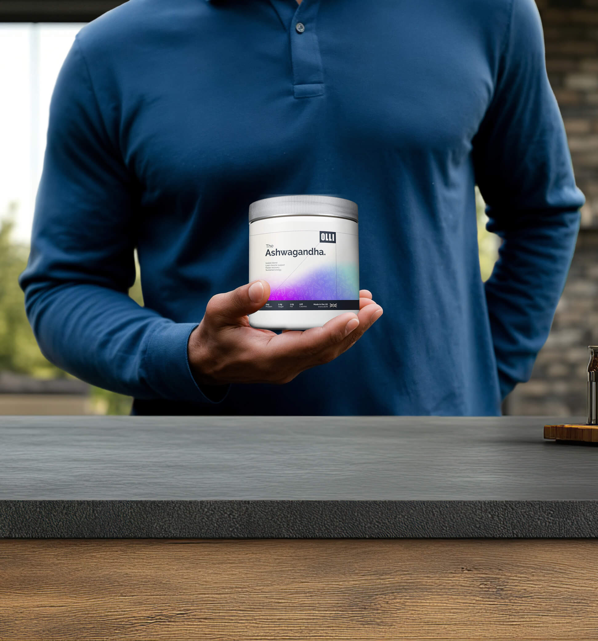 Man holding OLLI Ashwagandha supplement